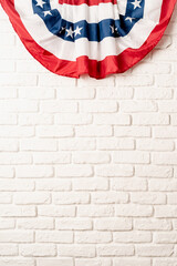 USA national flag on white brick wall background with copy space