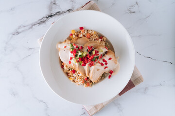 Cauliflower with chicken Breast and tomato in a dish isolated on mat top view on grey marble background
