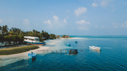Fototapeta na wymiar Aerial View to the Maafushi (Kaafu Atoll) Paradise Island with Blue Ocean Water and Paradise Coastline, Maldives