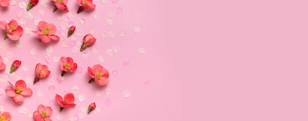 Spring background. Beautiful delicate fresh pink flowers and buds, paper confetti on pink background flat lay top view. Springtime nature concept. Bloom, inflorescence, flowering. Festive backdrop