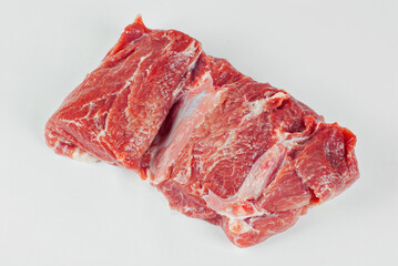 Red meat close up. Piece of pork isolated on a white background. Preparation for meat dishes.