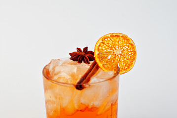 Orange cocktail on a white background. Alcoholic drink with ice close up. Copy space and wine place for text near the glass.