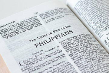 Philippians open Holy Bible Book close-up. New Testament Scripture. Studying the Word of God Jesus Christ. Christian biblical concept of faith and trust.