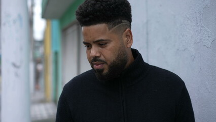 A thoughtful black man standing in urban street a thoughtful person