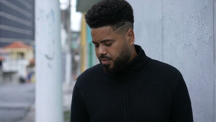 A thoughtful black man standing in urban street a thoughtful person