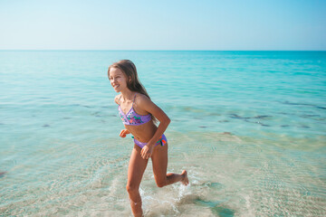 Fototapeta premium Cute little girl at beach during caribbean vacation