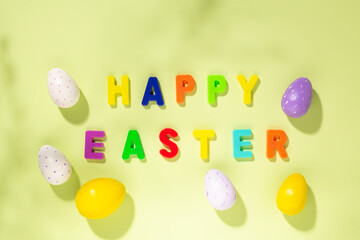 Easter card. Multicolored letters making the words Happy Easter and colorful eggs. Top view