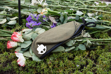 Flowers and a green beret are laid on the grave of a fallen soldier in Jerusalem's Har Herzl...