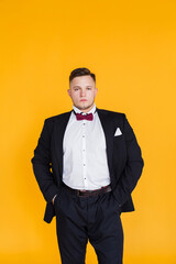 Portrait of an attractive 25 year man, future generation, businessman on yellow background in Ukraine.