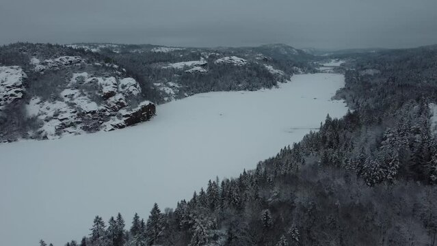 Nearing Lake Dingle Dam Through Snow Covered Mountain Trees Sweden 4K 30fps