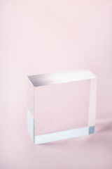 Acrylic Solid Display Block for Shop Windows on pink background, empty podium for product...