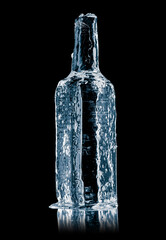 Ice sculpture in form of a glass bottle, made of textured pure ice on a black reflective surface.