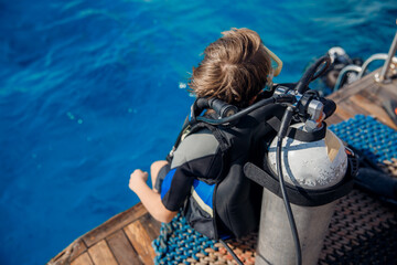 Child men with scuba diving blue water sea on boat