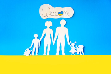ukrainian families are welcome with their children and pets. paper cutout on the colors of the flag...