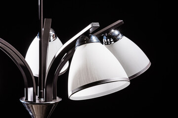 Modern lamp, chandelier on a black background. Lighting element of the interior.