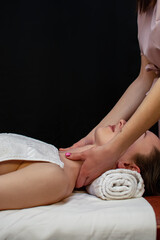Young woman relaxes on thai massage, close up