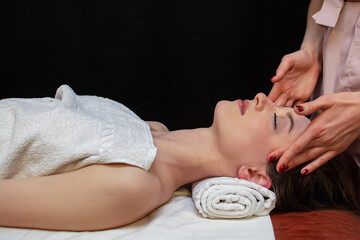 Obraz na płótnie Canvas Young woman relaxes on thai massage, close up