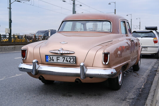 Istanbul, Turkey - February 26, 2022 : Rear view of a vintage but in good condition Studebaker, which is an American Classic Car was parked on The Galata Bridge in Istanbul.  