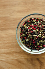peppercorns Isolated, spices, red pepper, black, white green.  Photo of spices in a glass bowl on a wooden background, cooking ingredients, top view, space for text, Flat lay, flatly, lay out