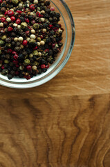 peppercorns Isolated, spices, red pepper, black, white green.  Photo of spices in a glass bowl on a wooden background, cooking ingredients, top view, space for text, Flat lay, flatly, lay out
