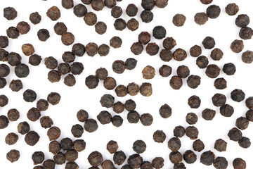 pile of black pepper seeds. isolated white background	