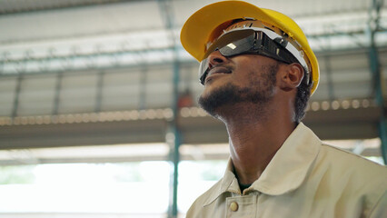 Close up portrait of confident Africa American engineer man wearing safety helmet and black glasses...