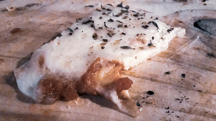 Fototapeta premium Piece of Pizza Over Wooden Table