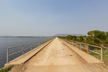 Concrete bridge by a large pond