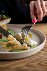 Close up of eating, hands only visible, female hands with pink manicure