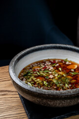 Close up of gourmet russian okroshka with kvas, soft light, dark photo