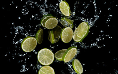 Freeze motion of sliced limes in water splash.