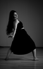 Beautiful modern ballet dancer on tiptoe posing in studio. Extreme flexibility.