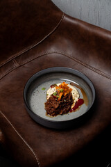Expensive meal placed on deep brown leather armchair, modern cuisine restaurant photo