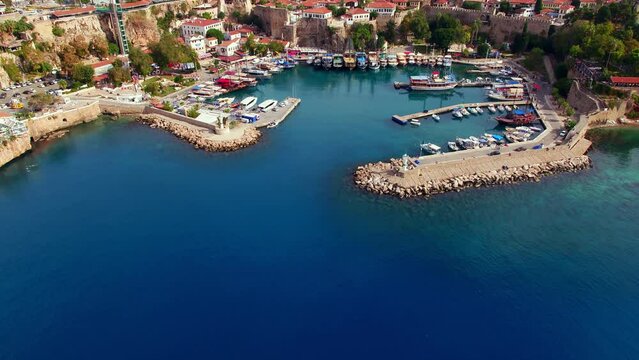 Aerial wide angle establishing view of Antalya Old Town Kaleici area Fluted Minaret and Cityscape
