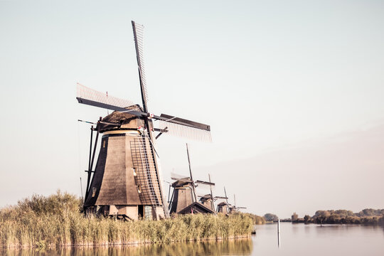 Horizontal picture of the famous Dutch windmills at Kinderdijk, a UNESCO world heritage site. On the photo are five of the 19 windmills at Kinderdijk, South Holland, the Netherlands, which are built