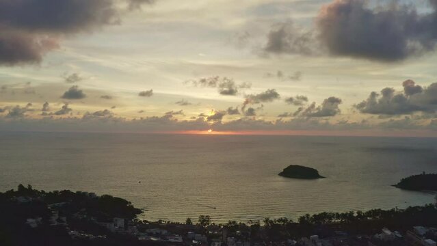 .aerial view scenery sweet sky in sunset above the island. .the sun going down to the sea beside Pu island at Kata beach Phuket Thailand.4k stock footage video in travel concept. sweet sky background.