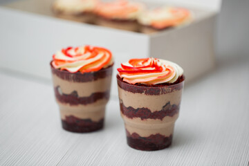 Trifles in plastic glasses.