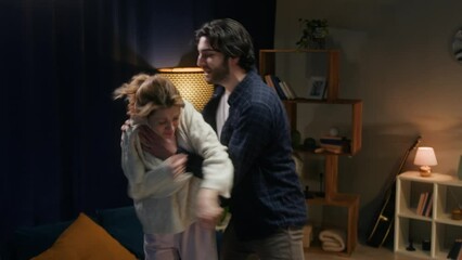 Man and woman fighting, couple quarreling at home, husband and wife shouting at each other and waving their hands. Scandal and crisis, family problems. Domestic violence, abuse.