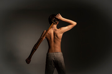 Rear view portrait of fitness teenager showing biceps