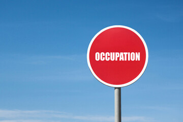 'Occupation' sign in red frame. Blue sky is on background