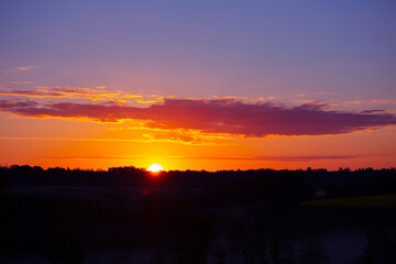 A beautiful spring sunrise with colorful skies. Seasonal scenery of Northern Europe.