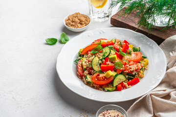 Tabbouleh salad, Levantine vegetarian salad with bulgur, quinoa, tomato, cucumber.