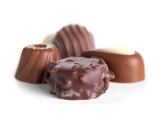 Assorted chocolate pralines or truffles. Closeup of a variety of small non uniform chocolate bonbon piece coated with dark chocolate and milk chocolate. Selective focus. Isolated on white.