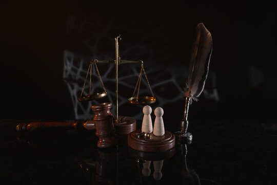 Law and Justice. Vertical image of judge gavel, wooden figures and wedding rings