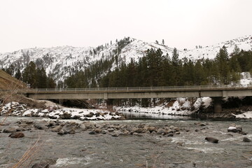 Bridge over river during winter