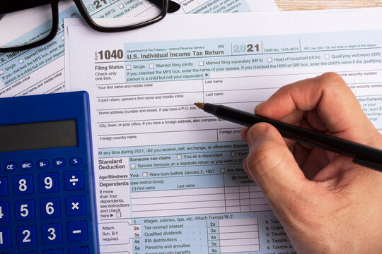Filling the Tax forms 1040. U.S Individual Income Tax Return on a desk.