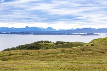 A view east towards the Scottish mainland across the Sound of Raasay from the north east coast of the Isle of Skye, Highland, Scotland UK. The Isles of Rona and Raasay are in the foreground.