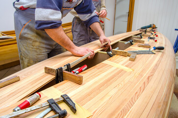 Carpenters making wooden boat in carpenter workshop - 490759528