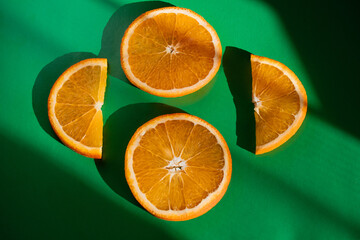 fruit slices of orange on green background