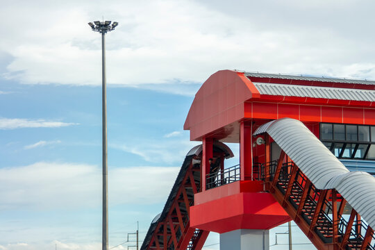 Overpass with red roof pedestrian crossing red gated walking path bridge